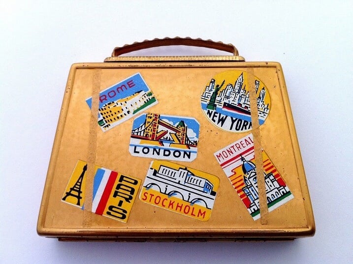 A vintage suitcase with travel stickers from across the world.